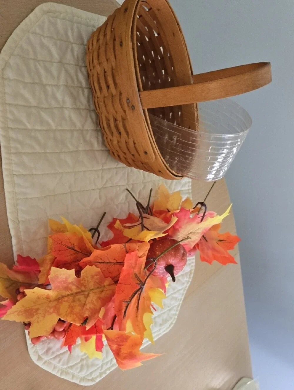 Longaberger woven basket with orange and yellow fall foliage